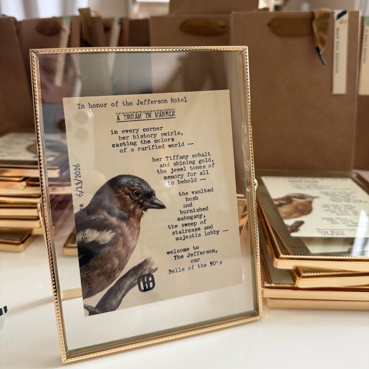 A framed typewritten poem, A Dream in Marble, written in honor of the Jefferson Hotel for the Southern Innkeepers Association conference at Boar&rsquo;s Head Resort, standing in front of more framed poems and gift bags