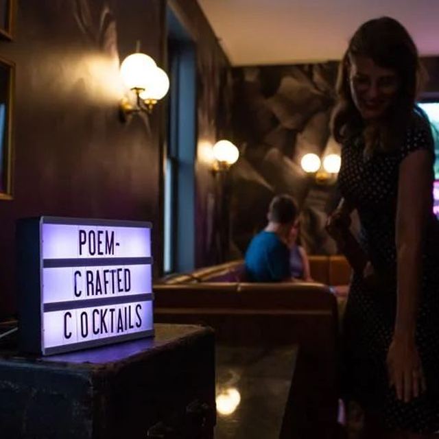Light box sign reading Poem-crafted Cocktails at Speakeasy & Whiskey Bar