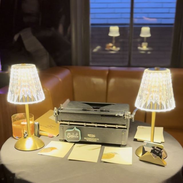 Vintage Royal typewriter, crystal lamps, and blank poem paper set up for an evening event