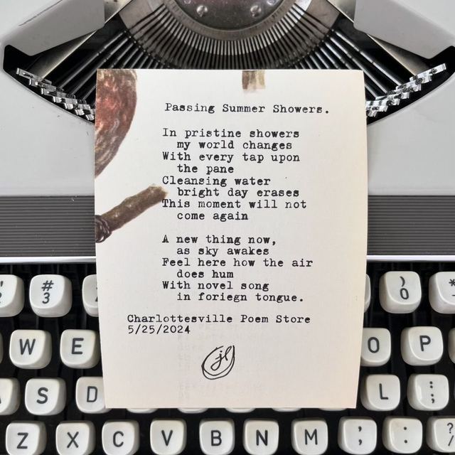 Poem &ldquo;Passing Summer Showers&rdquo; rolled into a vintage typewriter